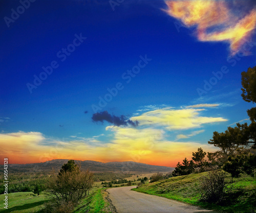 asphalt road with mountians