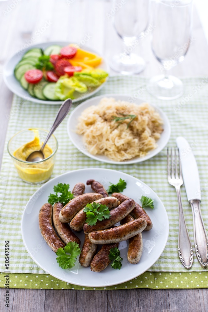 Nürnberger Bratwürste, Sauerkraut und Salat Nürnberger Bratwürste, Sauerkraut und Salat