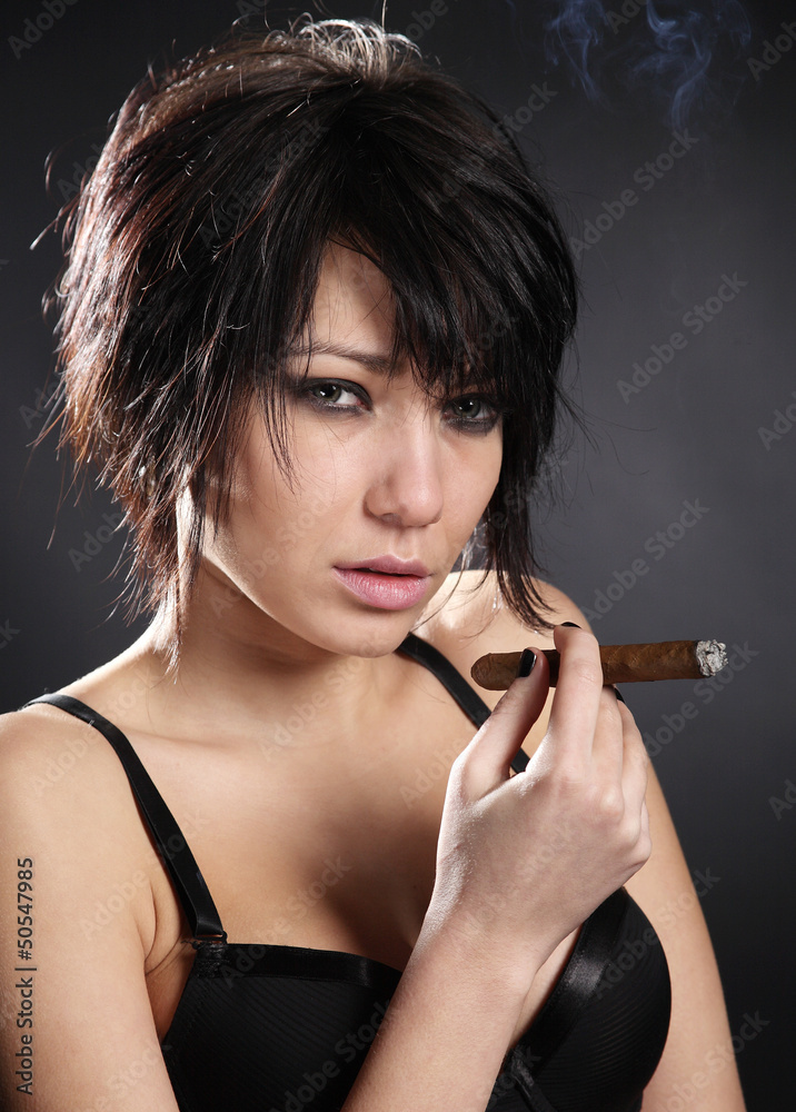 Obraz premium Hot sexy woman with bra smoking cigar