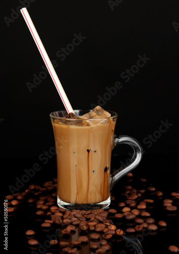 Cold coffee with ice in glass isolated on black