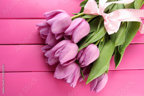 Fototapeta Naklejka Na Ścianę i Meble -  Beautiful bouquet of purple tulips on pink wooden background