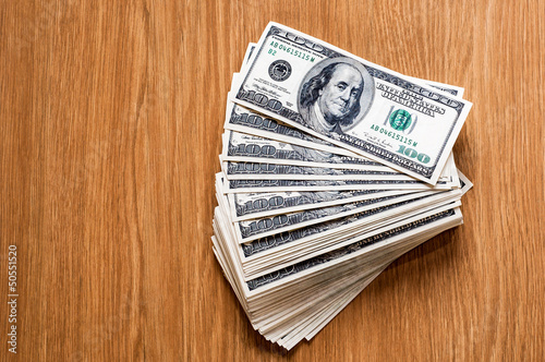 Pile of money over wood background