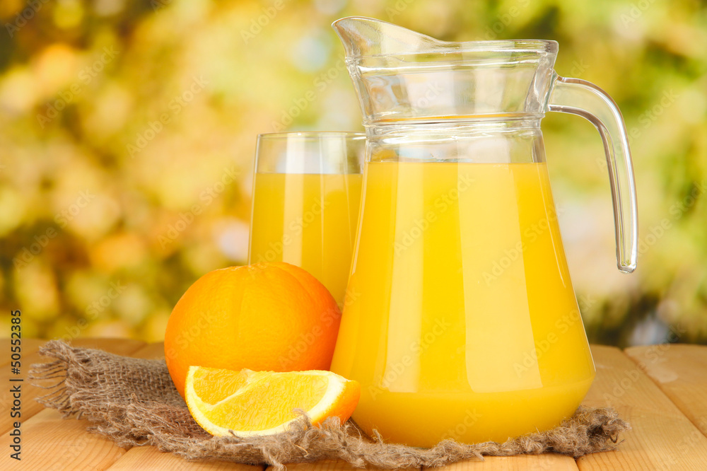 Full glass and jug of orange juice and oranges Full glass and jug of orange juice and oranges