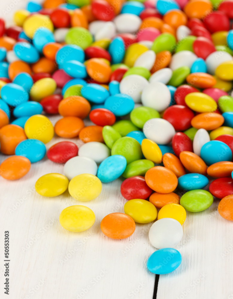 Colorful candies on white wooden background Colorful candies on white wooden background