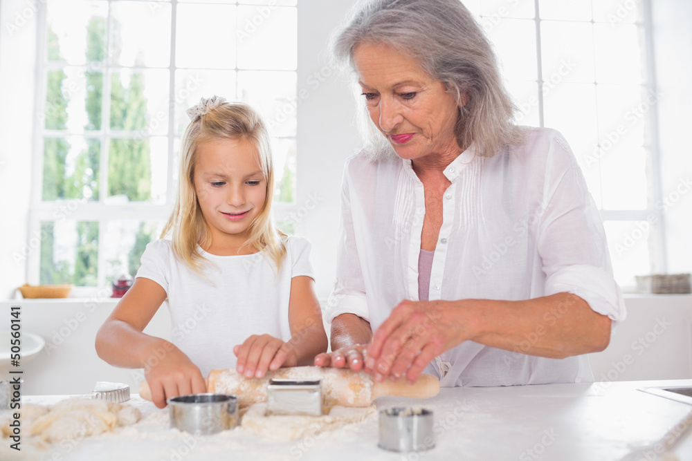 Grandmother and granddaughter making biscuits Grandmother and granddaughter making biscuits