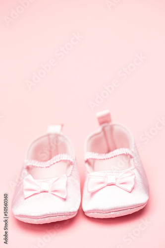 Baby girls pink booties with copy space