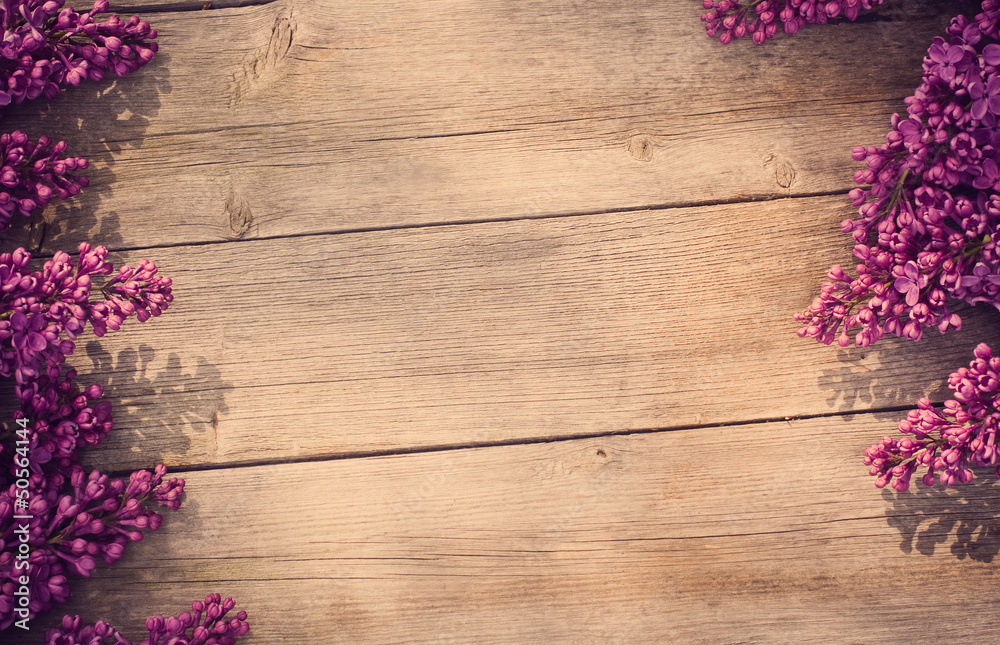 The beautiful lilac on a wooden background The beautiful lilac on a wooden background