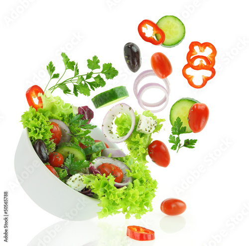 Canvas Print Fresh mixed vegetables falling into a bowl of salad