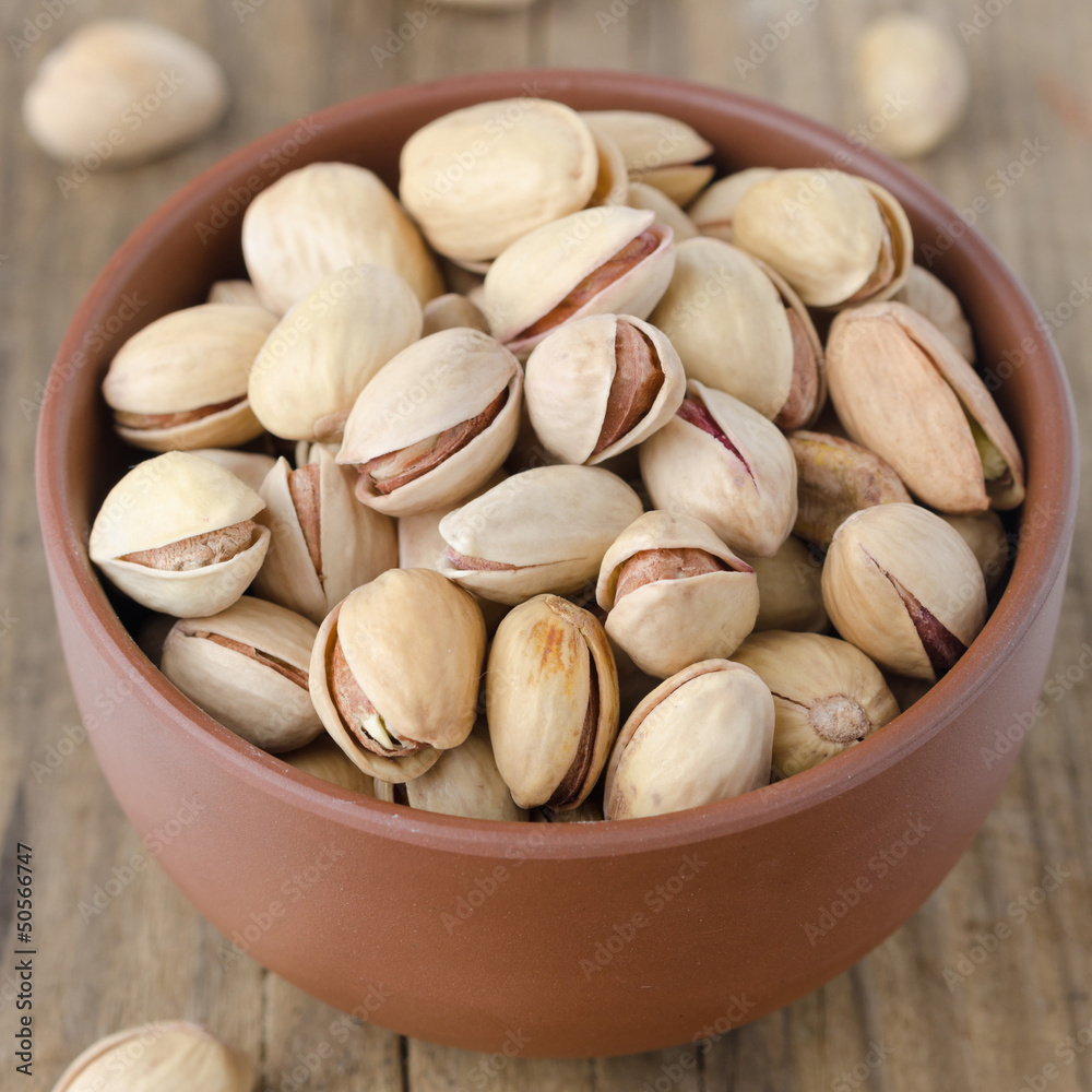 Pistachios in a brown ceramic bowl Pistachios in a brown ceramic bowl