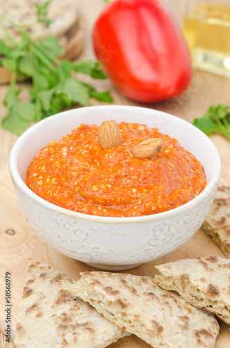 roasted pepper dip with almonds and garlic in a bowl vertical