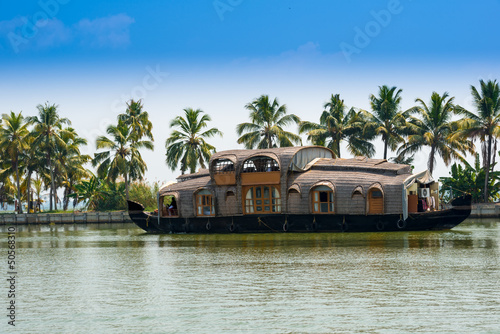 landscape with reflection houseboat in kerala backwaters, India photo