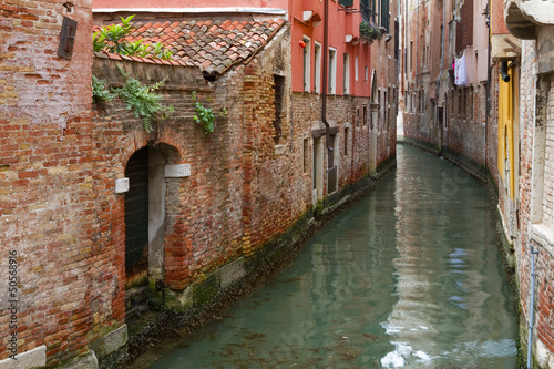 Narrow canal in Venice, Italy.