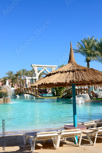 Fototapeta Naklejka Na Ścianę i Meble -  Sunbeds near swimming pool at luxury hotel, Sharm el Sheikh, Egy