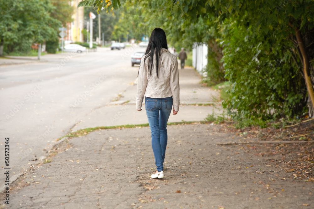 girl goes on city street in the autumn afternoon girl goes on city street in the autumn afternoon