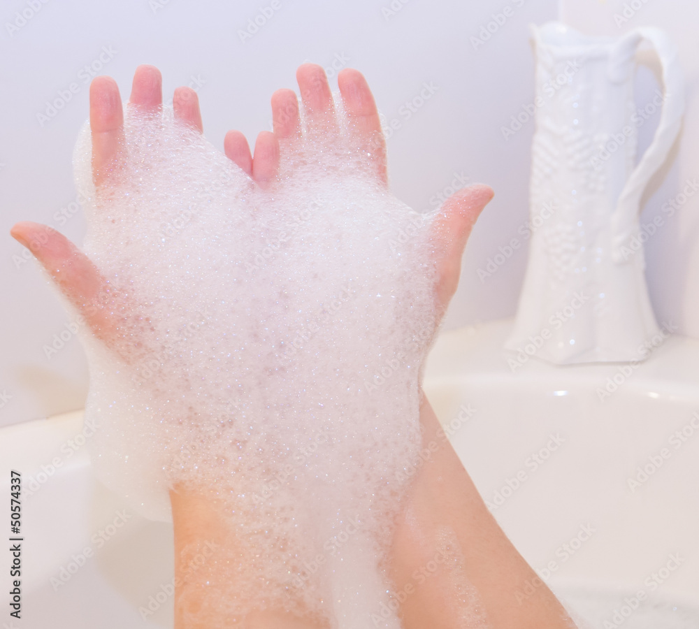 Fototapeta premium Soap foam on hands in bath