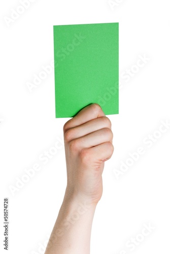 hand holding a green tag