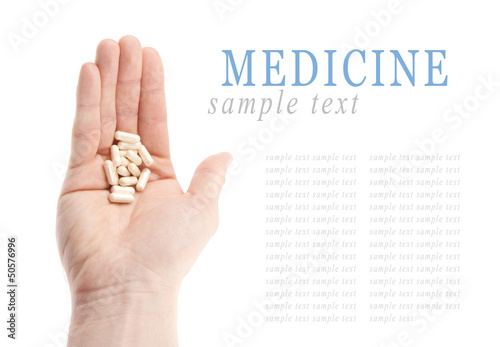 Pills on hand isolated on white