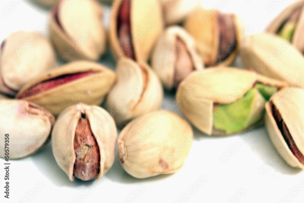 pistachios nuts on a light background pistachios nuts on a light background