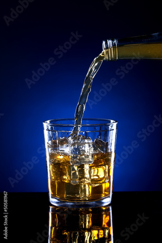 Small glass of poured alcohol.
