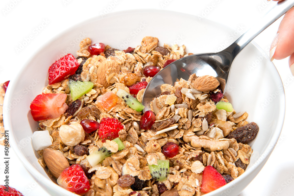 Muesli cereals bowl and spoon with almond, pine nuts Muesli cereals bowl and spoon with almond, pine nuts