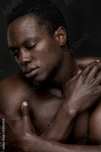 Topless African American Man with Hand to Face 