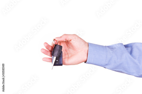 Male hand holding a car key . New car concept