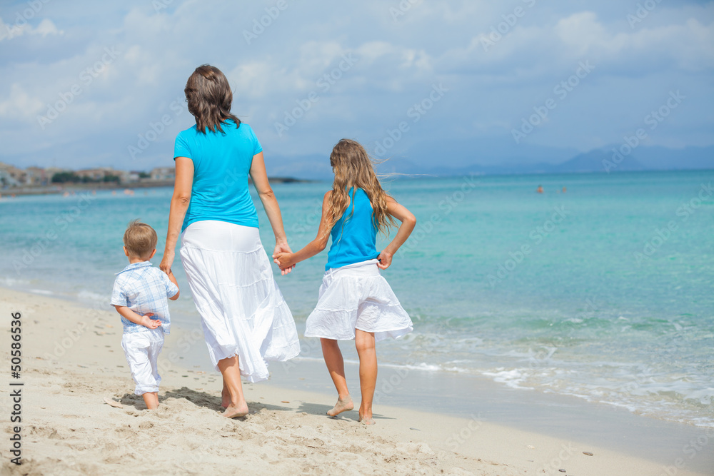 Mother with his two kids on beach