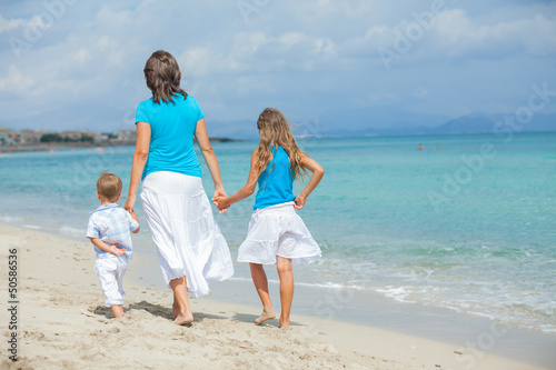 Mother with his two kids on beach