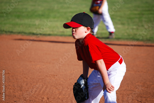 Youth baseball player hands on knees