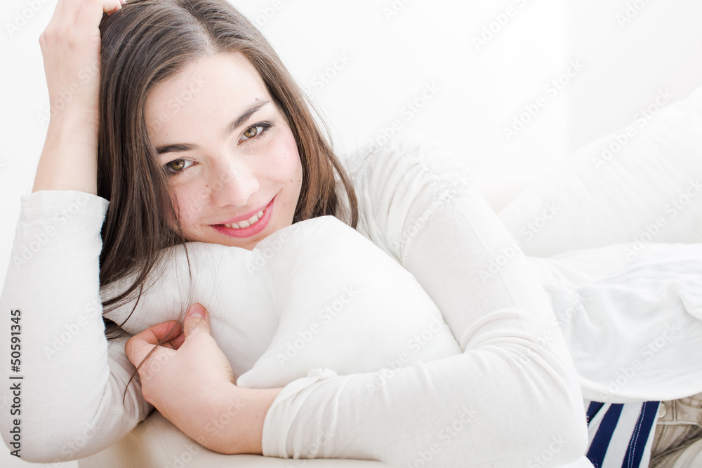 Young woman relaxing and smiling at home Young woman relaxing and smiling at home