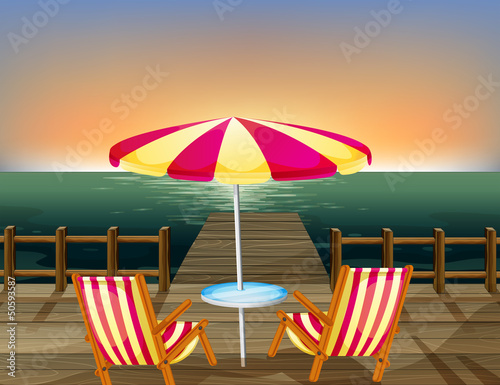 A wooden bridge with an umbrella and chairs