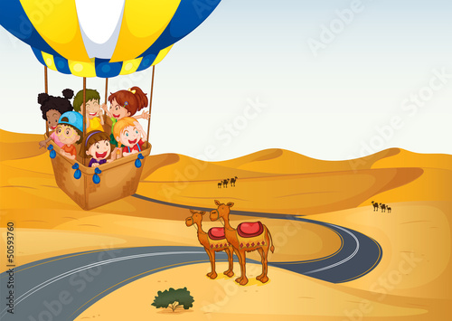 The hot air balloon with kids at the desert