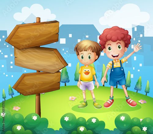 The wooden arrow beside the two young boys