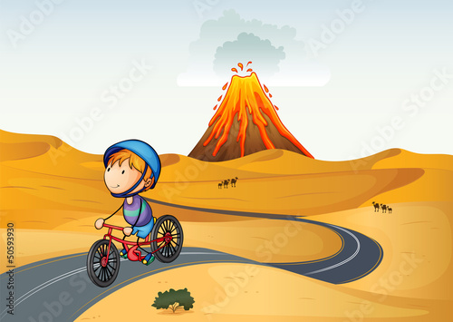 A boy riding a bike in the desert