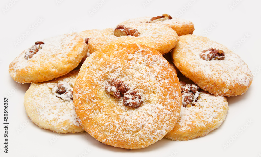 Heap of delicious cookies icing sugar with walnut isolated