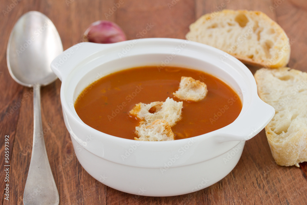 tomato soup with bread in white bowl