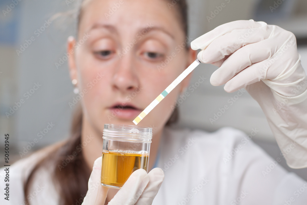 Woman making urine test Woman making urine test