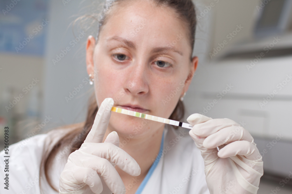 Woman making urine test