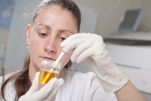Woman making urine test