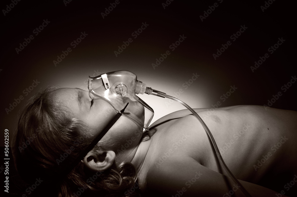 Little girl in mask of oxygen.