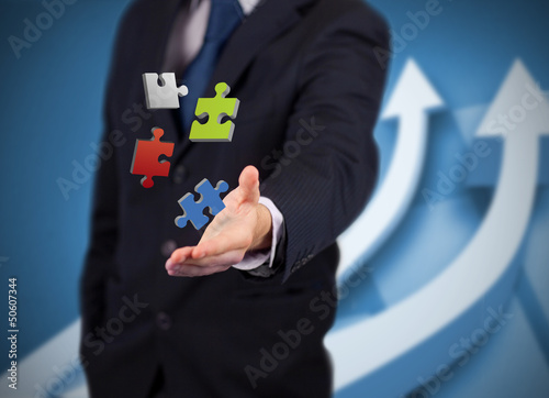 Businessman with digital puzzles