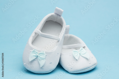 Baby booties with blue ribbon
