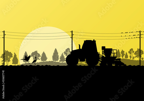 Agriculture tractor sowing crop in cultivated country field land