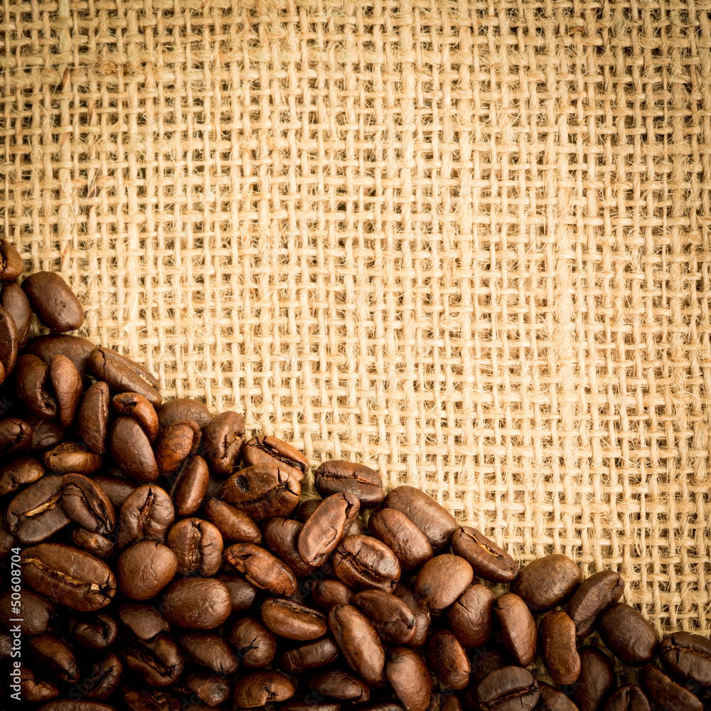 Burlap sack and pile of coffee beans with copy space Burlap sack and pile of coffee beans with copy space