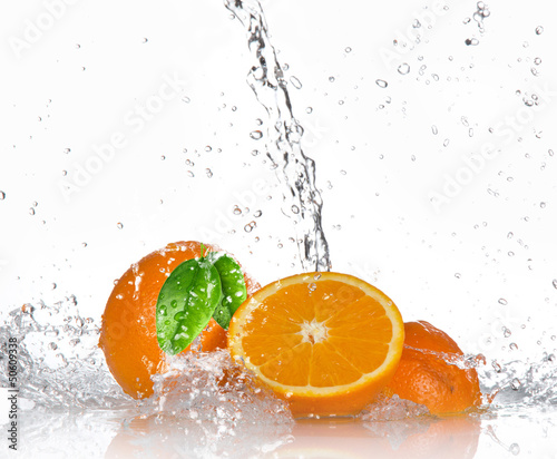 Oranges with splashing water