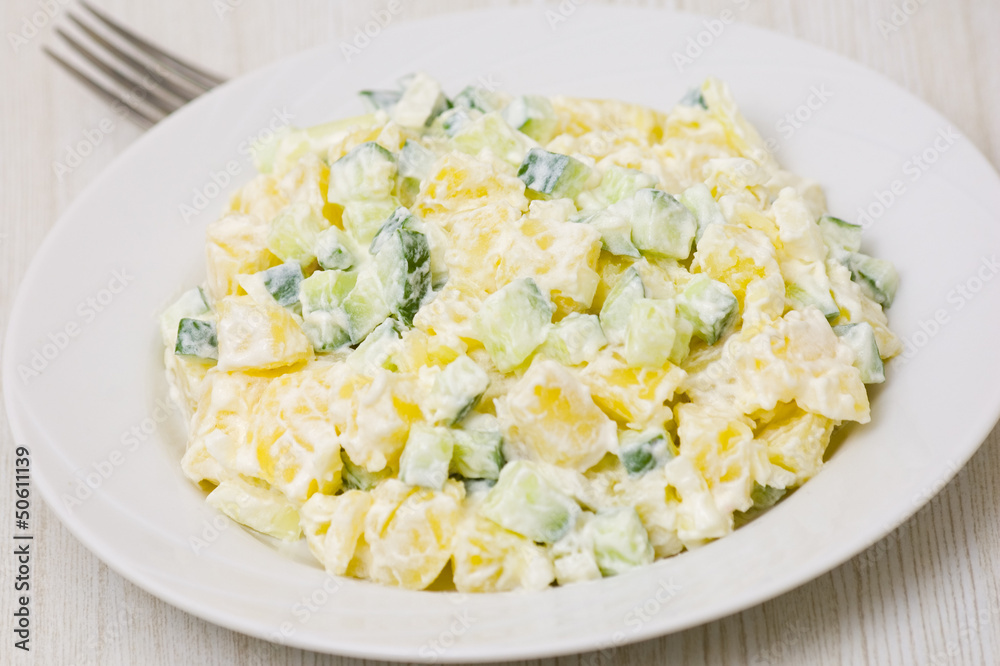 Potato salad with onions and cucumber with a mayonnaise-cream
