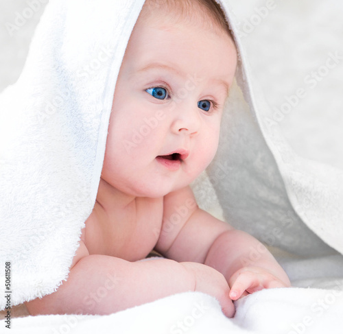 baby under the white blanket