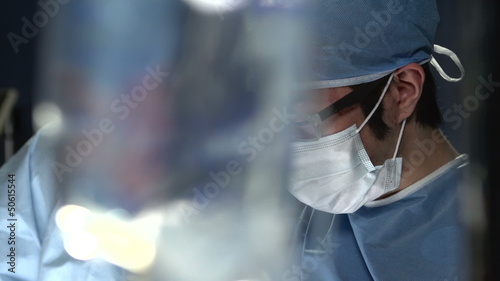 Asian surgeon working with assistant