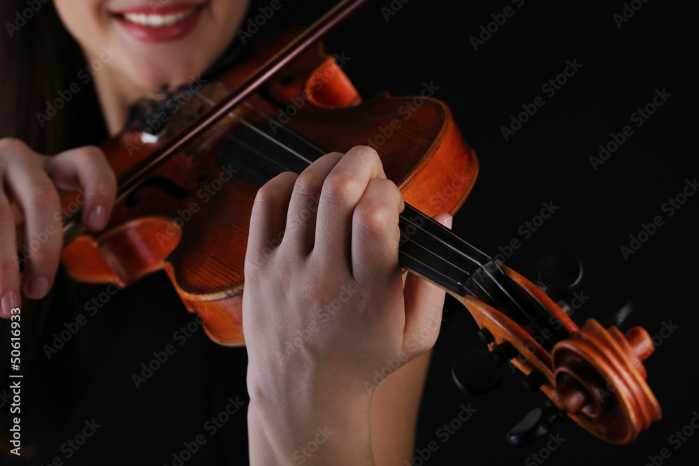 Musician playing violin on black background Musician playing violin on black background