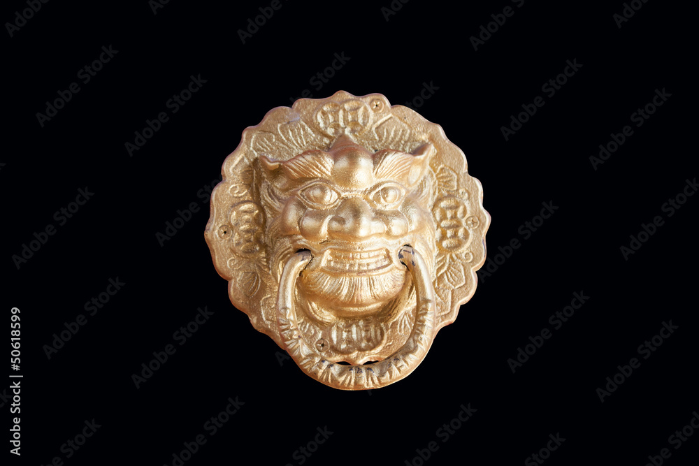 Golden lion head knocker isolated on the black background Golden lion head knocker isolated on the black background